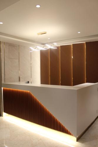 a lobby with a staircase in a building at The Vantage Inn, near US Consulate Gachibowli Hyderabad in Hyderabad