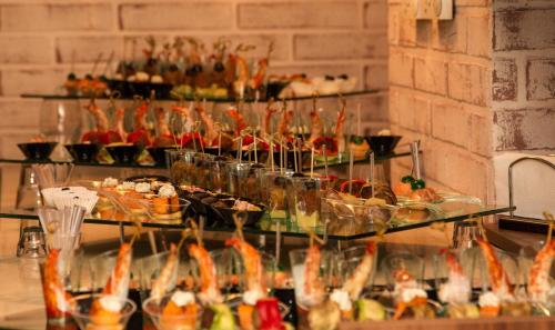 a buffet of food on display on a table at Triada Hotel in Sofia