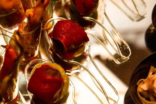 a bunch of food in glasses with strawberries in them at Triada Hotel in Sofia