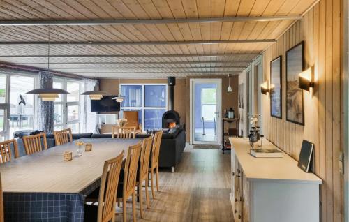 a kitchen and living room with a large table and chairs at Nice Home In Nørre Nebel With Sauna in Nørre Nebel