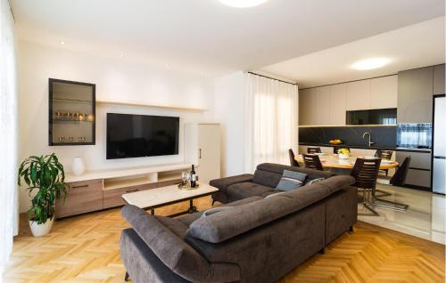 a living room with a couch and a tv at Apartment Pojlicka Cesta Iv in Krilo