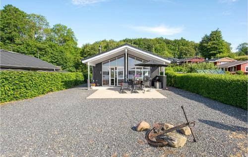a house with a glass door and a table at Holiday Home Sønderballevej Rødekro I in Diernæs