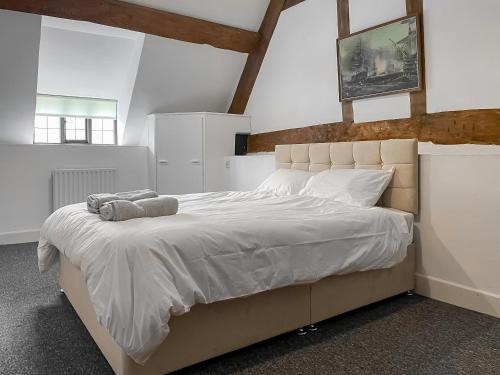 a bedroom with a large bed with white sheets at Ashford Old Farm in Ilton