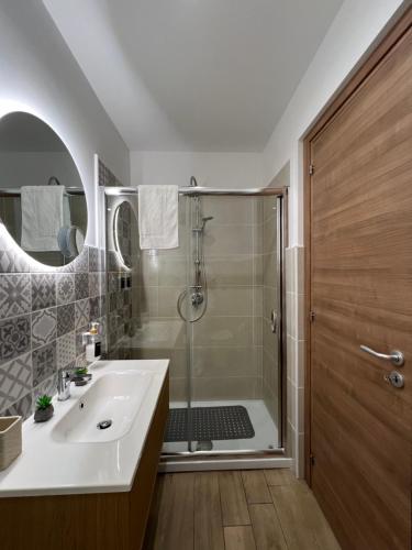 a bathroom with a shower and a sink and a tub at Dimora del Pescatore - Holiday House in Cefalù