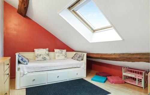 a attic bedroom with a bed and a skylight at Nice Home In Bayel With Wifi in Bayel