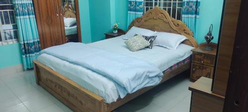 a bed with two pillows on it in a bedroom at Zuned Homes Sylhet in Sylhet