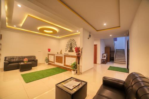 a living room with a couch and a table at HOTEL VISA INN NEAR KEMPEGOWDA AIRPORT in Bengaluru