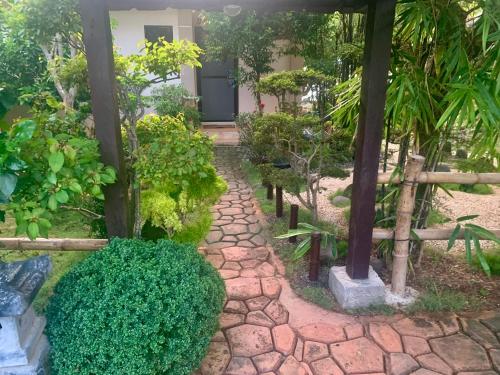 a garden with a stone walkway in front of a house at Adayo Cove Resort in Siquijor