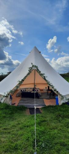 a tent with a car parked inside of it at Summit Camping Kit Hill Cornwall Stunning Views Pitch Up or book Bella the Bell Tent in Callington
