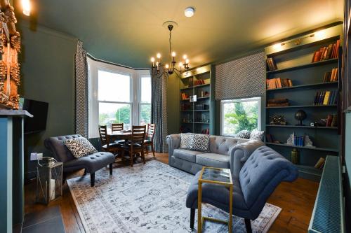 a living room with a couch and chairs and a table at Fairview Boutique Apartments in West Bridgford Centre in Nottingham