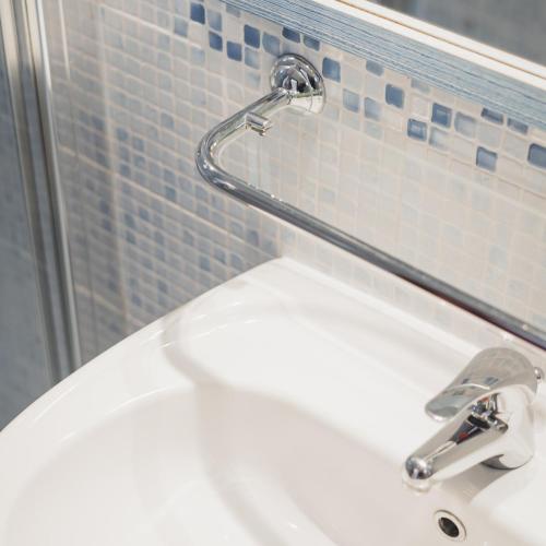 a bathroom sink with a faucet on a wall at Hotel Jesulum in Lido di Jesolo