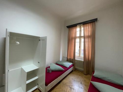 a small room with a bed and a window at MINATO Apartments Ostrava center in Ostrava