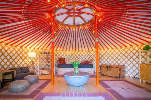 a yurt with a bowl in the middle of a room at Jurta pod Kriváňom in Vavrišovo