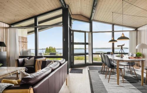 a living room with a couch and a table at Amazing Home In Aabenraa With Kitchen in Aabenraa