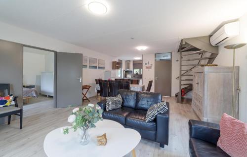 a living room with a couch and a table at Beautiful Home In Wemeldinge With Wifi in Wemeldinge
