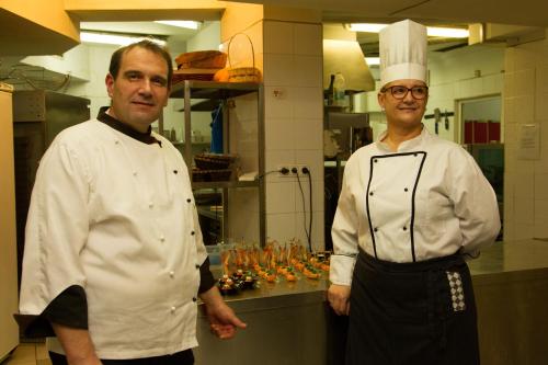 two chefs standing next to each other in a kitchen at Triada Hotel in Sofia