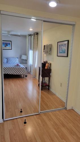 a mirror in a room with a bedroom and a bed at Unit 4 - Walkable Roosevelt Row 1BR 1BA Downtown Stay in Phoenix