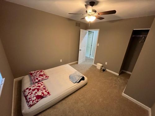 a bedroom with a bed and a ceiling fan at Entire House Towson / Baltimore in Towson
