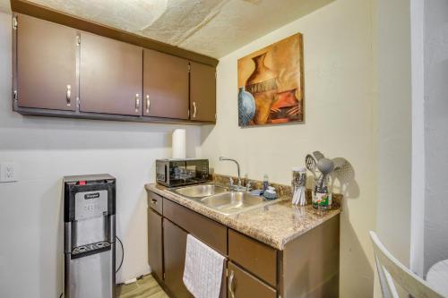 a small kitchen with a sink and a microwave at El Centro Retreat Near Local Parks and Golf Courses in El Centro