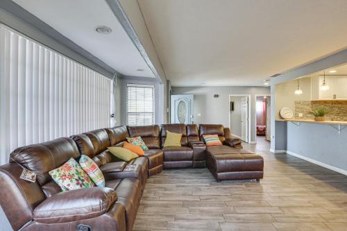a living room with a brown leather couch at Updated El Centro Home with Private Patio in El Centro
