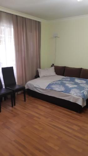 a bedroom with a bed and a chair and a window at Luiza Guest House in Areni