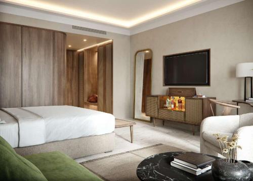 Habitación de hotel con cama y TV en Isla Brown Chania Resort, Curio Collection by Hilton, en Stavros