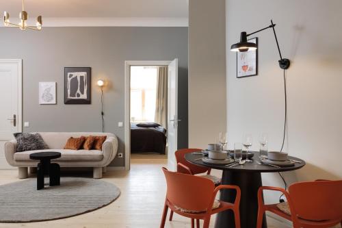 a living room with a table and a couch at Centra Nams - Center Apartments in Cēsis