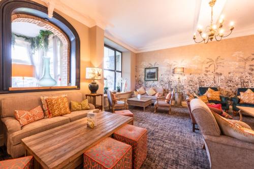 a living room with a couch and a table at The Moorland Hotel, Haytor, Devon - The Coaching Inn Group in Haytor