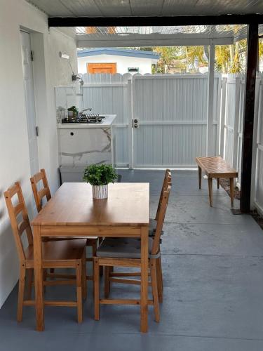 a wooden table and chairs on a patio at Adrien Guest Studio in Miami Gardens