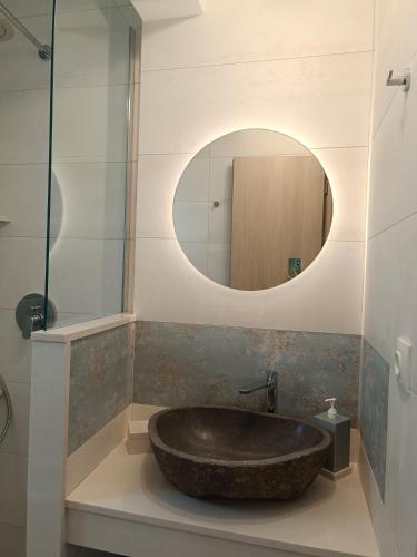 a bathroom with a stone sink and a mirror at Nesea 2 in Psérimos