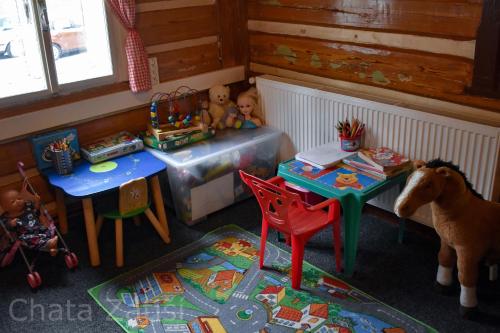 a toy room with two tables and a toy goat at Penzion chalupa Lesní zátiší in Harrachov