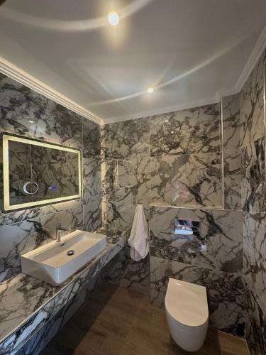 a bathroom with a sink and a toilet at Stamos Apartments and Studios in Vourvourou