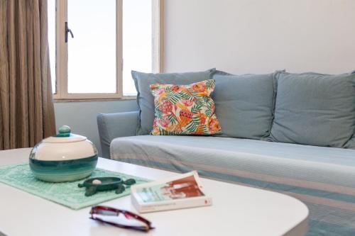 a living room with a couch and a table at Sa Dommu e Mare in Santa Maria Navarrese