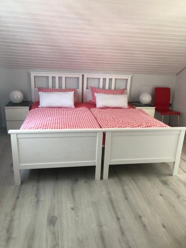 a large white bed with two pillows on it at Ferienwohnungen Gabi Karnowski in Gernsbach