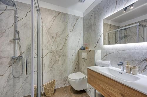 a bathroom with a shower and a toilet and a sink at Casa Fortunato with Private Pool in Pićan
