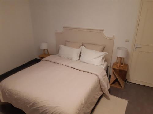 1 dormitorio con 1 cama blanca grande y 2 lámparas en Urban Chic 44 m2, en Brest