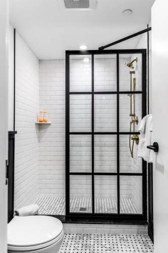 a bathroom with a shower and a toilet in it at King Bed, Historic Hotel, Bangor, Room # 101 in Bangor