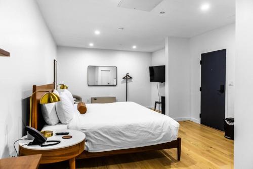 a bedroom with a white bed and a table at King Bed, Historic Hotel, Bangor, Room # 101 in Bangor