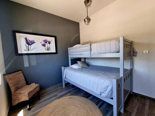 a bedroom with two bunk beds and a chair at Ideal home for your next get away in San Miguel de Allende