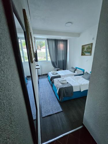 a hotel room with two beds and a window at Uptown Inn in Sarajevo