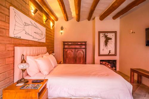 a bedroom with a large bed and a fireplace at Hotel Caney Villa de Leyva in Villa de Leyva