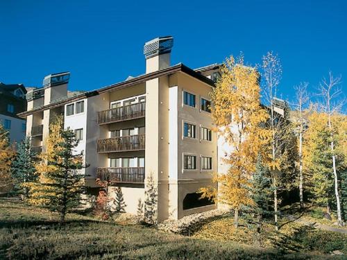 a large apartment building with trees in front of it at Townsend Place in Beaver Creek
