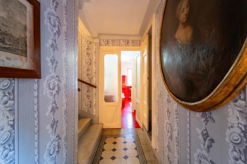 a hallway with a painting of a woman on the wall at Villa Lucia a Laglio by Wonderful Italy in Laglio