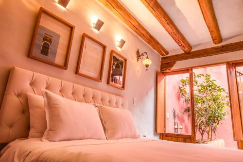 a bedroom with a large bed and a window at Hotel Caney Villa de Leyva in Villa de Leyva