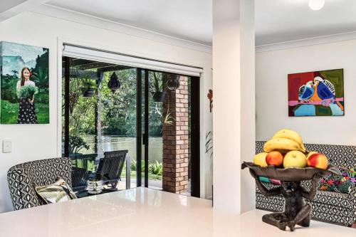 a kitchen with a bowl of fruit on a table at Riverfront Oasis in Elanora in Gold Coast