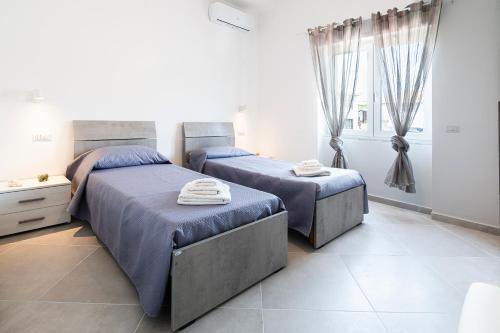 En eller flere senge i et værelse på Casa Di Gregorio - Intero Appartamento