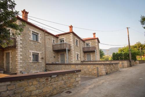 an old stone building with a stone wall at Villavia Residence - Sorocco & Ostria Retreats with Pool access in Megáli Mandínia
