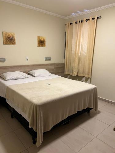 a bedroom with a large bed in a room at Hotel Makuxis - Brigadeiro in Sao Paulo