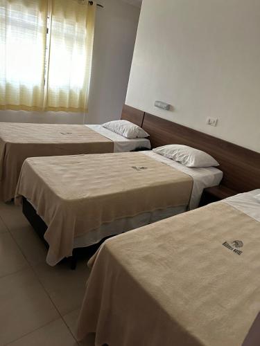 three beds in a hospital room with a window at Hotel Makuxis - Brigadeiro in Sao Paulo