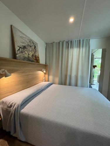 a bedroom with a large white bed and a window at Palazzo delle Biscie - Old Tower & Village in Molinella
